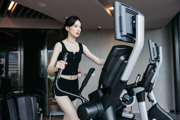 Woman Exercising on Elliptical Cross Trainer