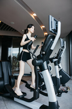 Woman Exercising on Elliptical Cross Trainer