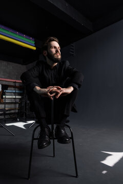 Man poses for photo on chair