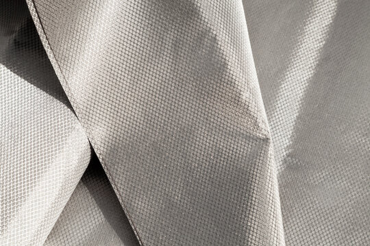 Protective RFID, EMI, cell signal blocking Faraday fabric. Shielding conductive cloth with metal grid that blocks wireless signals, EMF radiation