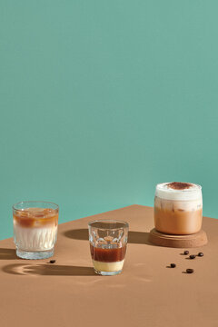Set with different types of coffee drinks on a brown table