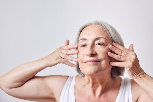 Female Pensioner Doing Skin Care Routine