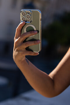 Crop woman taking photo on smartphone