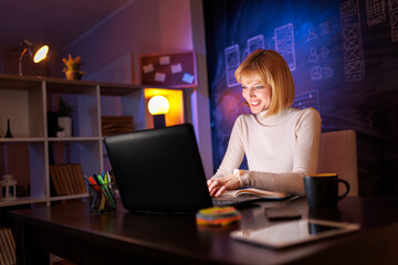 Woman using laptop computer at night