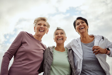 Diversity, happy women and laughing for sports, fitness and support on mockup sky background. Low angle, senior female group and exercise friends excited for community wellness, freedom or motivation