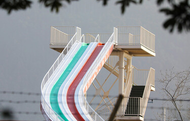 Iconic giant slide built into an outdoor pool facility