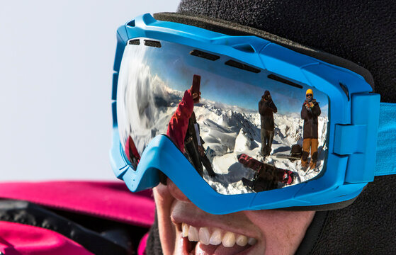 A Reflection In A Female Skier's Goggles As She Takes A Selfie Around Cerro Catedral