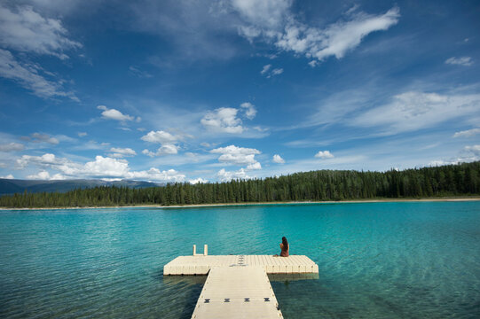 View of woman sitting on platform, British Columbia, Canada
