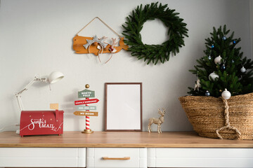 Mockup of a wooden frame in the interior of a room decorated for Christmas