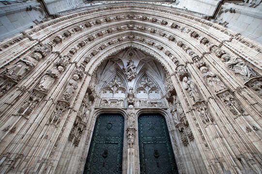 A detail view of a gothic-style portal, or doorway, on a Spanish cathedral.