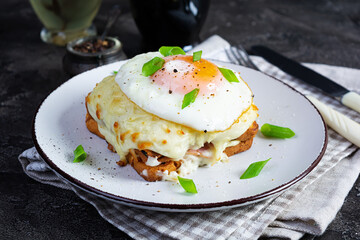 Delicious breakfast. Hot french toast with ham and bechamel sauce - croque madame