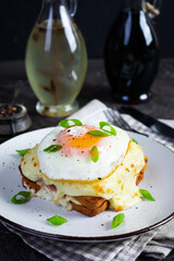 Delicious breakfast. Hot french toast with ham and bechamel sauce - croque madame