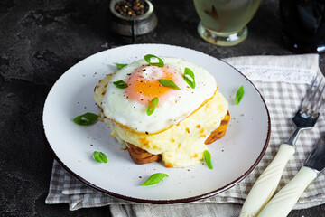 Delicious breakfast. Hot french toast with ham and bechamel sauce - croque madame