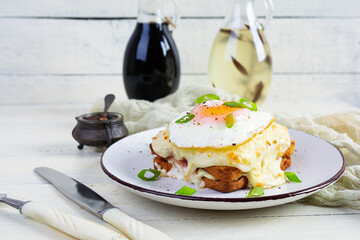 Delicious breakfast. Hot french toast with ham and bechamel sauce - croque madame