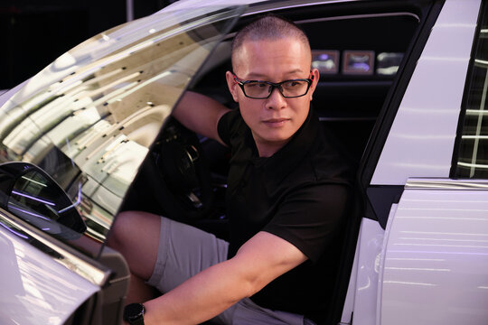 Asian man and new electric energy car