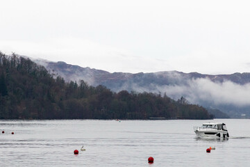 Boat passing the mountains on lake Windemere