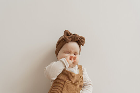 Baby girl smells something stinky. 