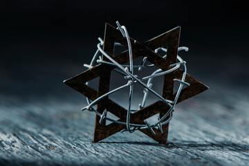 star of david tied with some barbed wire