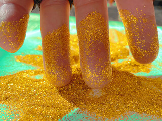 Fingers play with shiny New Year's decoration