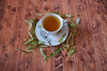 Fototapeta na wymiar Linden tea and linden plant on wooden background.