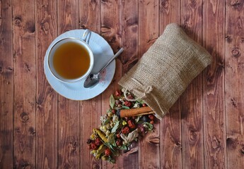 Winter tea. Winter tea plants in a pouch. Wooden floor.