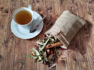 Winter tea. Winter tea plants in a pouch. Wooden floor.