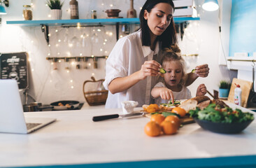 Mother and daughter preparing healthy breakfast at kitchen