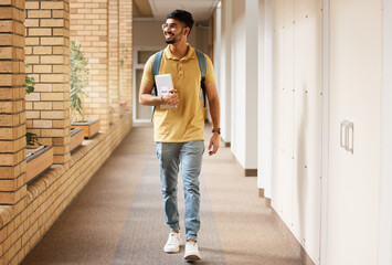 University student, college and indian man walking with a smile and backpack down campus corridor. Gen z male happy about education, learning and future after studying with scholarship at school - Powered by Adobe