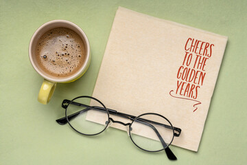 Cheers to the golden years - cheerful note on a napkin with a copy space, retirement concept