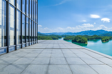 Empty square floor and glass wall with mountain background - Powered by Adobe