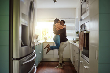 Black couple, happy home and love while together with care and happiness in a marriage with commitment and care. Young man and woman hug while in the kitchen to celebrate their house or apartment