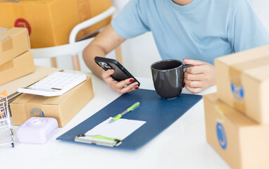 start-up operator Small Business SME Freelance Young woman working from home with box on table Packaging, marketing, SME, delivery. E-commerce concept.