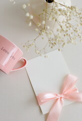 Valentine's day greeting card mockup and vase with gypsophila flowers, top view, flatlay, copy...