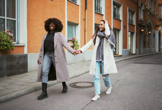 Fashion, Holding Hands And Lesbian Couple Walking In Street Enjoying Holiday, Vacation And Adventure On Weekend. Love, Lgbtq Relationship And Women Together For Happy Lifestyle, Freedom And Relaxing