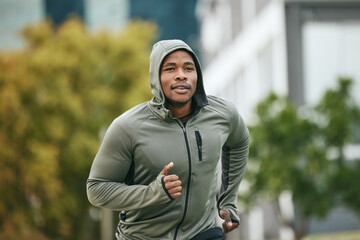 Fitness, runner or black man running in city for body training, exercise or workout with focus in Miami, Florida. Freedom, mindset or healthy sports athlete with wellness goals, motivation or mission