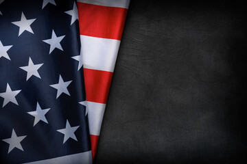 USA flag on a dark background. American flag on the background of a dark canvas for a patriotic concept and national celebrations.