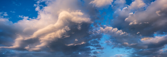 Panoramic background of evening sky with dramatic stormy clouds