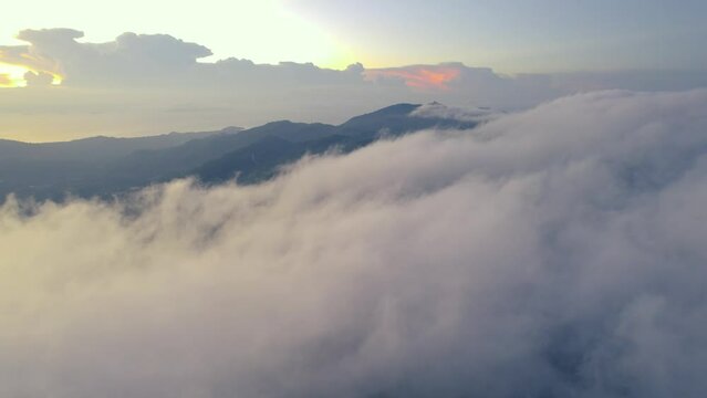 Cinematic fly over clouds in sunset, Samui, Thailand