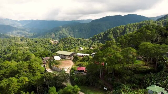 Aerial footage of village inSagada, Mountain Province, Philippines with Cordillera mountains in the background using DJI Mini 2. Peaceful and simple rural living in the countryside of the Philippines.