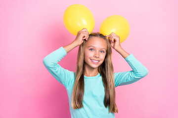 Closeup photo of young little pretty cute small schoolkid girl toothy smile hold yellow air balloon bunny positive enjoy event isolated on pink color background