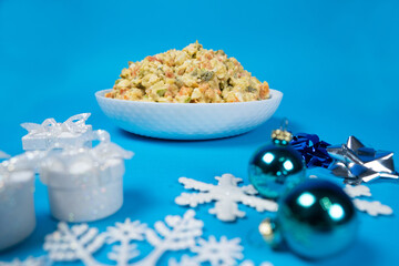 Olivier Russian salad, Christmas and New Year food, blue background.