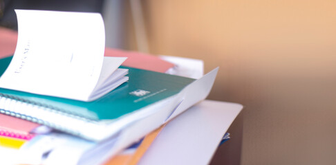 Stack of papers and notebooks on the table