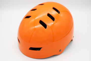 An orange helmet on a white background designed for BMX bicycle riders' protection