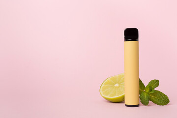 Disposable electronic cigarette with fruit on color background