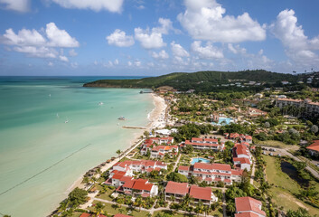The drone aerial view of Dickenson Bay beach, Antigua. Dickenson Bay is on the Northwestern coast...