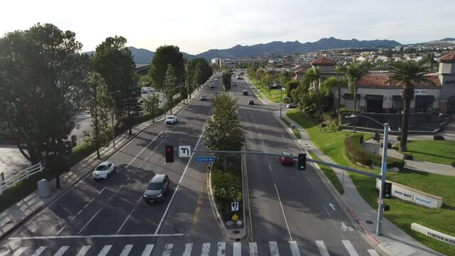 cars pass by on suburban road 