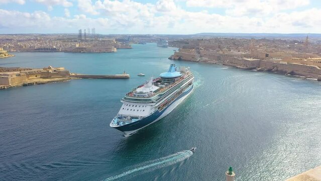 Cruise liner ship in ocean floats out of the historic bay. Aerial top view