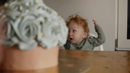 Baby red head girl desiring some cake for her birthday.