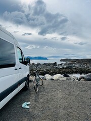 Fototapeta na wymiar Parked van and bicycle in front of the sea
