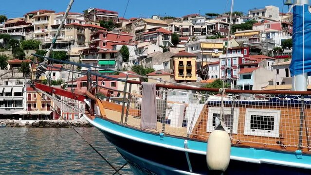 Parga Greece 07.11.2019 Retro tourist boat with a village in the background